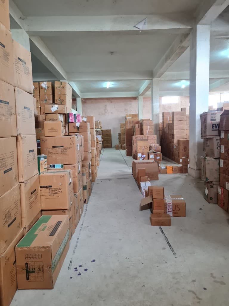 Packed cartons arranged in a warehouse aisle for super stockist inventory in Ranchi