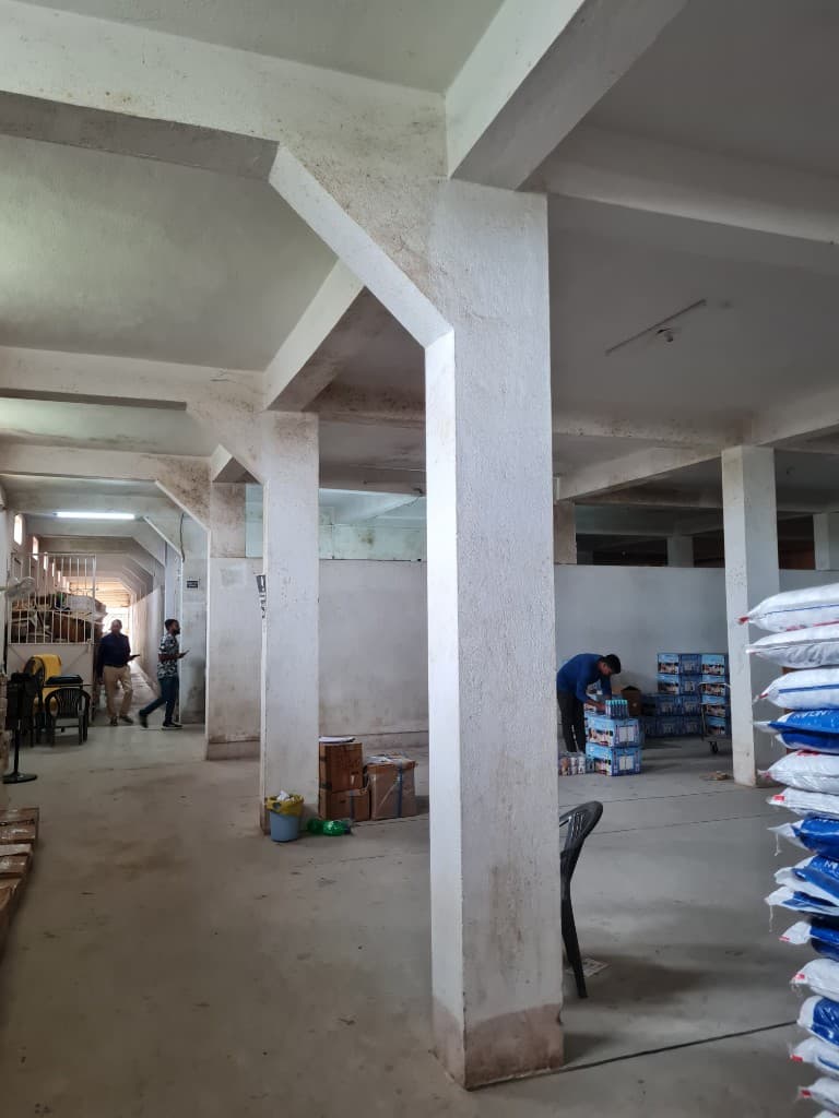 Warehouse interior with concrete pillars and stacked goods used for distribution operations in Ranchi